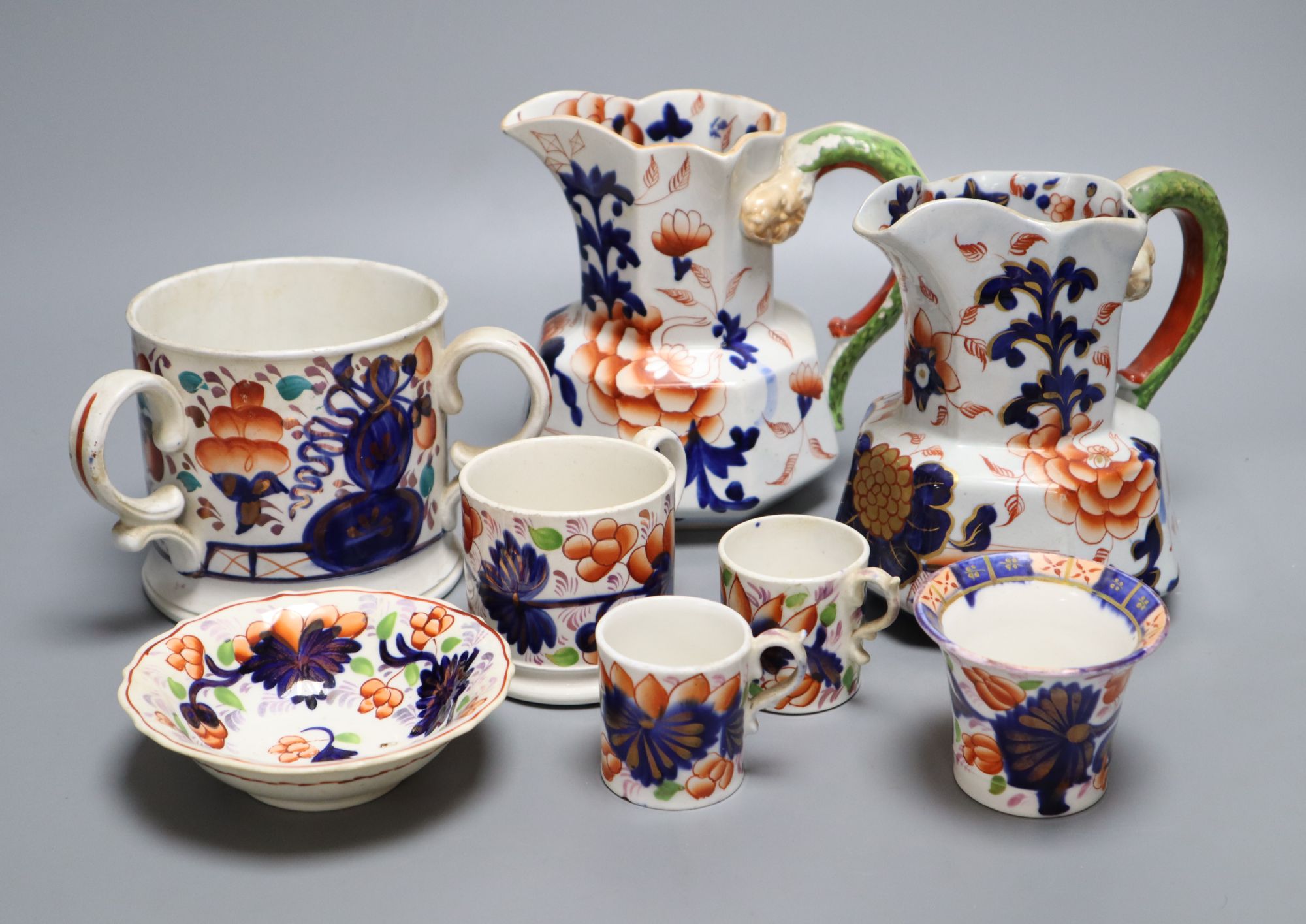 Eight pieces of Ironstone china including two jugs and a three handled cider mug